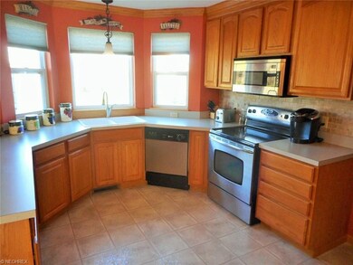 Kitchen with vinyl flooring, stainless steel appli