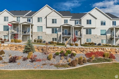 View of front facade featuring a residential view, board and batten siding, and stone siding