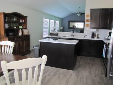 ALTERNATE VIEW OF KITCHEN LOOKING TOWARD LIVING RO