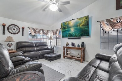 Living area with marble finish floor, a ceiling fa