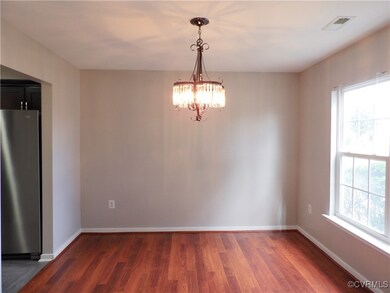 Unfurnished dining area with a chandelier, dark wo