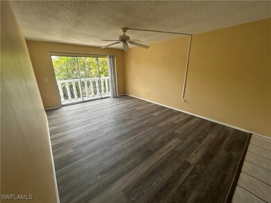 Empty room featuring ceiling fan, a textured ceili