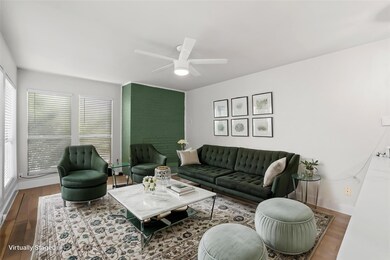 Living room featuring ceiling fan, wood finished 
