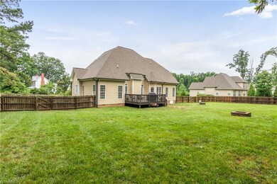 Large fenced in backyard with a deck great for entertaining.