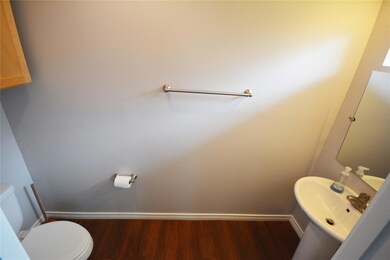 Bathroom featuring a sink, baseboards, toilet, an