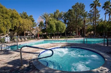Community pool with a hot tub and a patio area