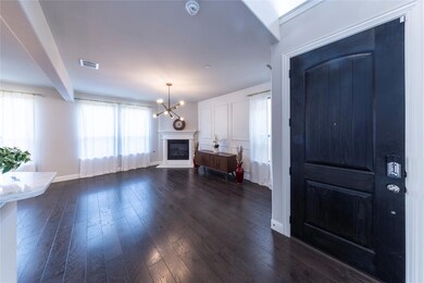Entrance foyer featuring a glass covered fireplace