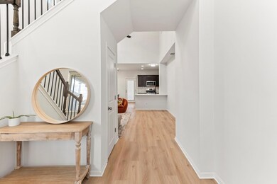 Hallway with light wood finished floors, lofted c