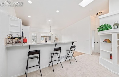 Kitchen featuring kitchen peninsula, a breakfast b
