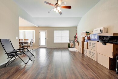Living room featuring ceiling fan, a gas fireplace
