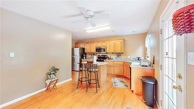 Hardwood flooring extends from kitchen to dining a