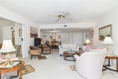 Carpeted living room featuring ceiling fan