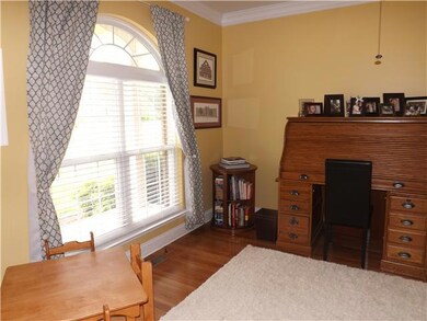 The home office has hardwood floors, huge bright window overlooking the front lawn and space for oversized furnishings. 