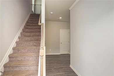 Stairway with wood finished floors, baseboards, and recessed lighting