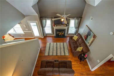 A view of the living room from the upstairs hallway.
