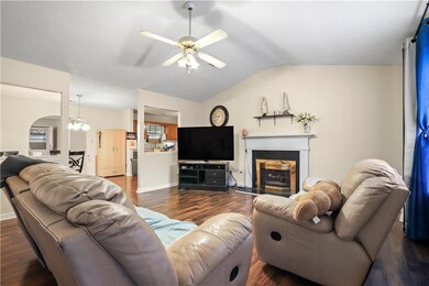 Living area featuring a glass covered fireplace, c