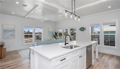 Kitchen featuring beamed ceiling, dishwasher, base