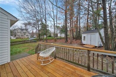 Wooden deck featuring a storage shed