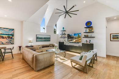 Living area with high vaulted ceiling, baseboards