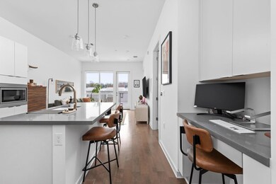 Kitchen with white cabinetry, stainless steel mic