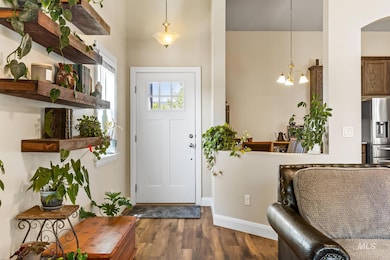 Entrance foyer featuring dark wood-type flooring and a chandelier