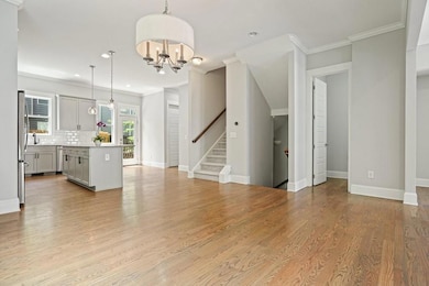 Unfurnished living room featuring ornamental moldi