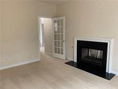 Unfurnished living room with carpet and a multi sided fireplace