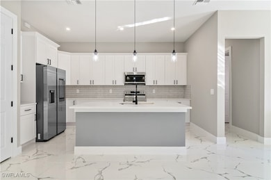 Kitchen featuring decorative backsplash, stainless