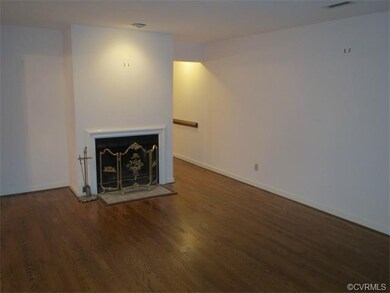 Living room with gleaming hardwoods and fireplace