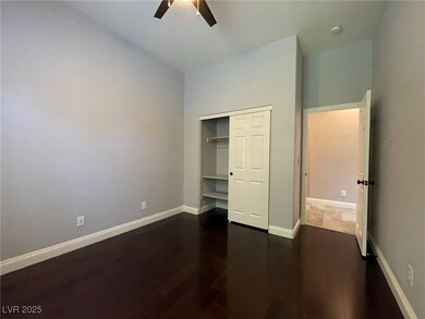 Unfurnished bedroom featuring dark wood-style floo