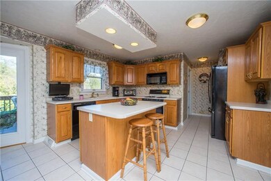 The fully equipped kitchen has a ceramic tile floo