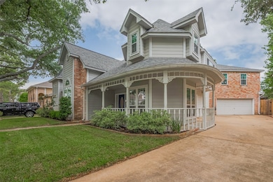A charming wrap around porch with intricate woodwo