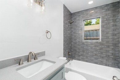Full bathroom with vanity, toilet, and tiled showe