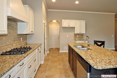 Gas cook top with travertine back splash and decor