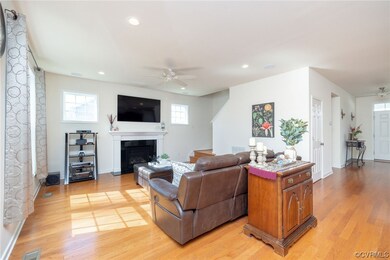 Living room with ceiling fan with notable chandeli