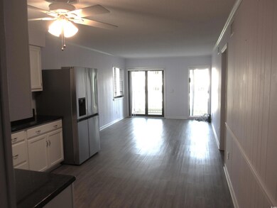Kitchen with white cabinetry, ornamental molding, 