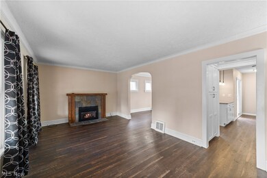 Unfurnished living room with a gas fireplace, ornamental molding, dark hardwood / wood-style floors, and a textured ceiling