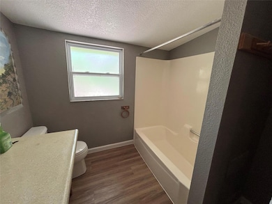 Full bathroom featuring wood finished floors, a t