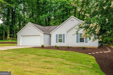 Single story home with a front lawn and driveway
