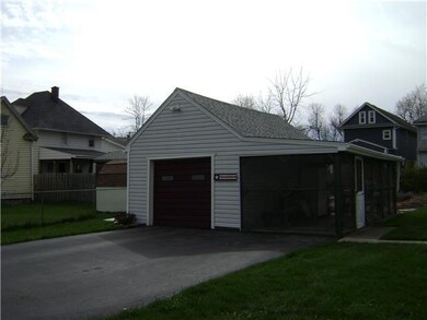 Exterior Front. Garage with screened in sun room.