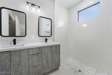 Bathroom featuring double vanity, a sink, and tile