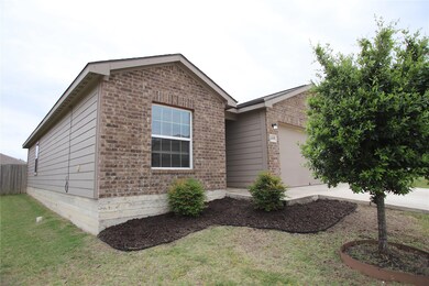 Ranch-style home featuring brick siding, a garage