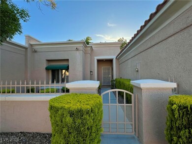 Property entrance featuring fence, stucco siding,