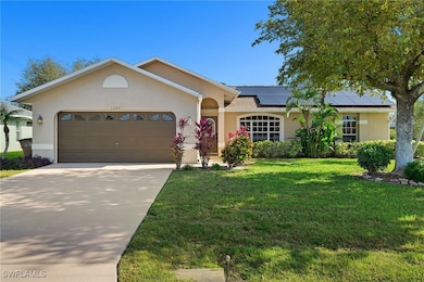 Ranch-style home with a front lawn, roof mounted s