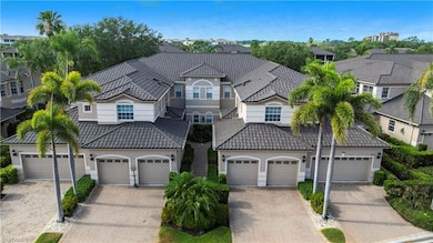 View of front of property featuring a tile roof, stucco siding, a residential view, and driveway