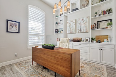 Office with built ins and french doors to the left at entry.