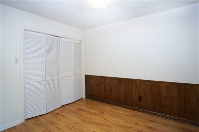 Unfurnished bedroom featuring a closet and light w