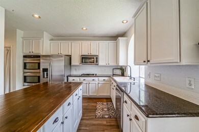 You'll enjoy convenient direct access from the dining room to this adjacent island kitchen. In the same space, you'll find the indoor utility closet and a bonus pantry to create additional storage space.