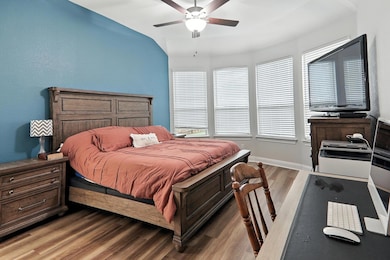 Bedroom featuring wood finished floors and a ceil