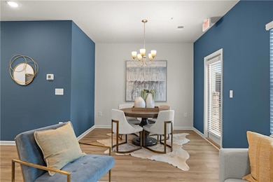 Dining area featuring a chandelier and light wood-type flooring